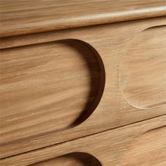 a close up of a wooden drawer with circles on it