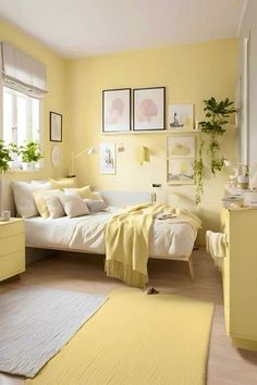 a bedroom with yellow walls and white bedding, rugs and pictures on the wall