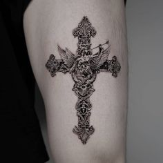 a black and white photo of a cross tattoo