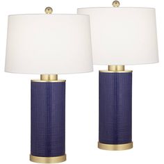 two blue lamps sitting next to each other on top of a white table lamp shade