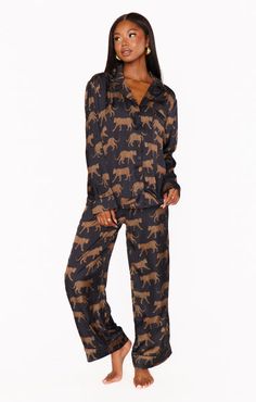 Embrace ultimate comfort and style with this captivating black pajama set adorned with a cat pattern. Indulge in the luxuriously soft, satin-feel fabric that drapes like a dream, both on the long-sleeve, flowy top and the matching pants. The playful... Black Pjs, Button Down Pajamas, Catwalk Design, Black Pajamas, Bodysuit Jumpsuit, Sleep Tight, Blouse Short Sleeve, Little White Dresses, 2024 Vision