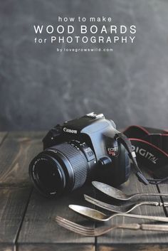 a camera sitting on top of a wooden table next to utensils and a knife