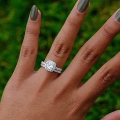 a woman's hand with two wedding rings on her left and the middle finger