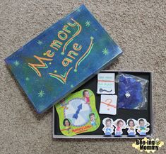 an open box with magnets and stickers on the floor next to some other items