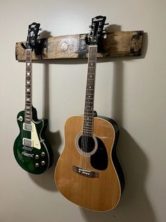 two guitars are hanging on the wall next to each other, one is green and one is brown