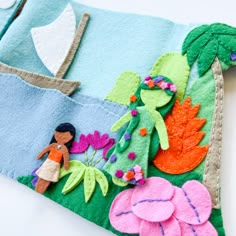 a hand made felt purse with flowers and a girl