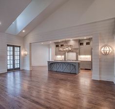 an empty living room with wood floors and white walls