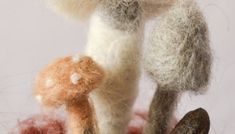 a stuffed animal is standing next to two other toy animals in the air with their tails curled up