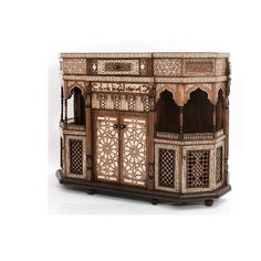 an elaborately carved wooden cabinet on wheels