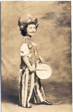 an old black and white photo of a young boy holding a frisbee