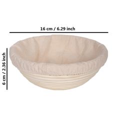 a large white bowl sitting on top of a table next to a measuring line with measurements