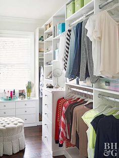 an organized closet with clothes, shoes and other items on shelves next to a window