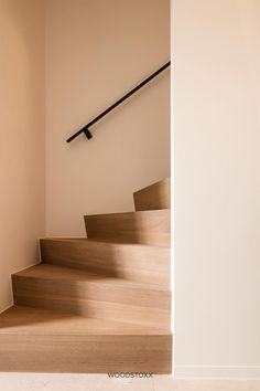 the stairs are made of wood and have metal handrails