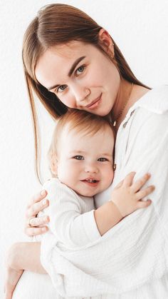 a woman holding a baby in her arms