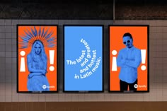 three billboards on the side of a building with blue and orange artwork behind them