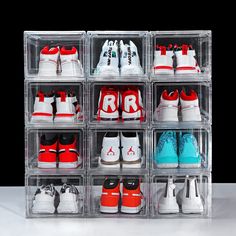 a clear box filled with lots of different types of shoes on top of each other