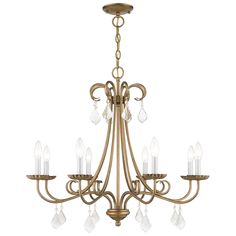 an antique brass chandelier with clear crystal drops on the arms and bottom lights