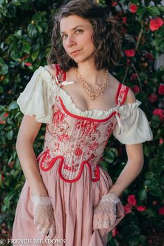 For the true princess of the high court, the Red and Pink Rococo Marie Stays make a statement in 18th century style.   Featuring a classic boned front and back lacing that makes adjusting a breeze, a low scooped neckline accentuates and hugs the bust while a curved lower panel detail draws the eye to the wearer's fitted waist. The boldness of this pink fabric is accented with specs of metallic gold, and a red cotton binding makes this corset pop. Truly a corset that is fit for a queen, the luxur Corset 18th Century, Pink Rococo, Cottagecore Princess, 18th Century Stays, Women's Costumes, Marie Antoinette, Pink Fabric, Rococo, Corset Top