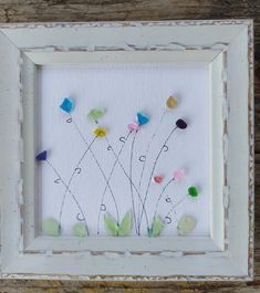 a white frame with some flowers in it