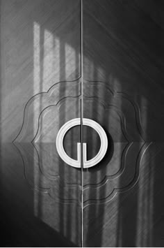 an image of a metal door with the letter o on it's side and light coming through