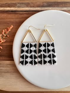 These earrings have a modern and lively feel with their matte white and black geometric design. Beaded fringe hangs from a beautiful gold plated triangular form with 14K gold plated hypoallergenic ear wires. **Each of my earrings are delicately handwoven bead by bead. I absolutely love making these and want you to know that each piece is made with patience and care from start to finish! These earrings are made with size 11/0 Delica Japanese Miyuki seed beads. I use strong nylon thread to ensure Minimalist Seed Bead Earrings, Checkered Beaded Earrings, Handmade White Rectangular Beaded Earrings, Beaded Jewelry Inspiration, Seed Bead Patterns Free, 2024 Jewelry, Seed Bead Jewelry Patterns, Beaded Fringe Earrings, Earring Inspo