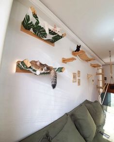 a living room filled with furniture and cats on the wall