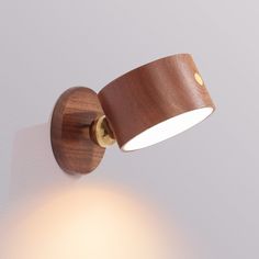 a wooden wall light on a white wall