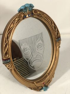 a mirror with a skull drawn on it and a comb in front of the mirror