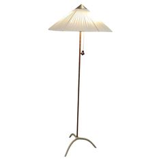 a floor lamp with a white shade on it