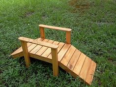 a wooden bench sitting on top of a lush green field