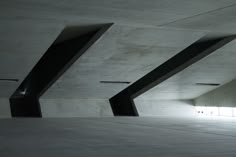 an empty parking garage with concrete walls and floor