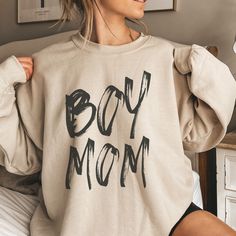 This adorable Boy Mom crewneck shows off your love of motherhood and chasing your boys around the playground or cuddling with them on the couch! This makes a perfect fall gift for the New Mom of Boys, Gender Reveal party, Mother's Day or Game Day. Gove the gift of a cozy sweatshirt to the Boy Mama in your life! Ideal for any situation, a unisex heavy blend crewneck sweatshirt is pure comfort. These garments are made from polyester and cotton. This combination helps designs come out looking fresh and beautiful. The collar is ribbed knit, so it retains its shape even after washing. There are no itchy side seams on these sweaters.  .: 50% cotton, 50% polyester .: Medium-heavy fabric (8.0 oz/yd² (271.25 g/m .: Loose fit .: Sewn-in label .: Runs true to size Boy Mom Shirt Ideas, Mom And Teen Son, Boy Mom Outfits, Mom Aesthetic Life, Boy Mama Shirts, Mommy And Me Outfits Boy, Boy Mom Aesthetic, Boy Mom Sweatshirt, Aesthetic Mom