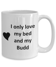 a white coffee mug with the words i only love my bed and my sam on it