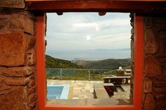 a window with a view of a pool and mountains