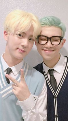 two young men with green hair posing for the camera