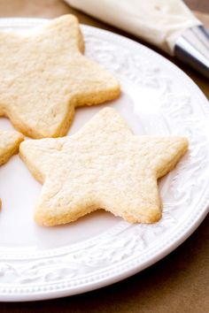 three star shaped cookies on a white plate