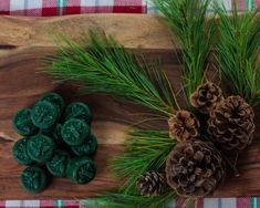 pine cones and wax on a cutting board next to some green waxed pine cones