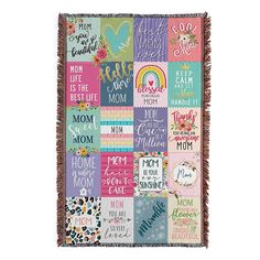 a multicolored blanket with many different words on it and a rainbow in the middle