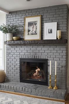 a living room with a fire place and pictures on the fireplace mantel above it