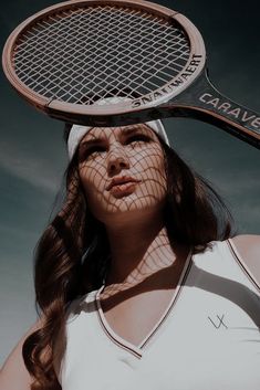 a woman holding a tennis racket over her head