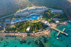 an aerial view of the resort and its surrounding grounds, with boats in the water