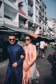 two people are walking down the street together