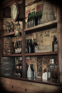 an old fashioned bar with lots of bottles and glasses on the shelves in front of it