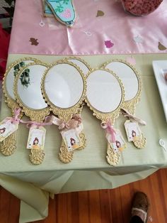 there are three plates on the table with pink ribbons around them and tags hanging from each plate