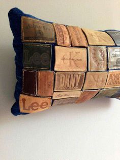 a decorative pillow made out of old wine corks is displayed on a wall in a home