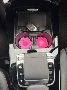 the interior of a car with pink flowers in it's center console and steering wheel