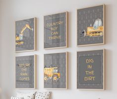 four framed pictures hang on the wall in a child's room with construction themed artwork