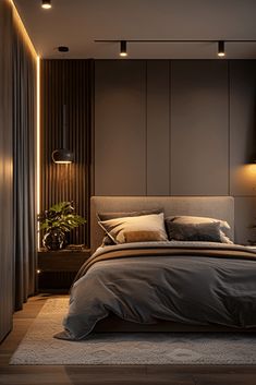 a large bed in a bedroom next to a wall with lights on it and a potted plant