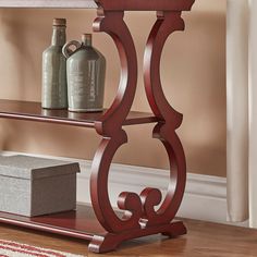 a wooden shelf with two bottles on it and a rug in front of the shelves