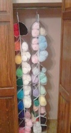 a closet filled with lots of colorful balls of yarn